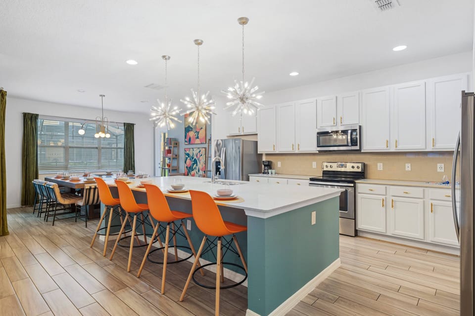 - Spacious kitchen with large island and seating for group  
- Bright pendant lighting adds stylish touch to open layout  
- Connected to dining area for family meals and gatherings