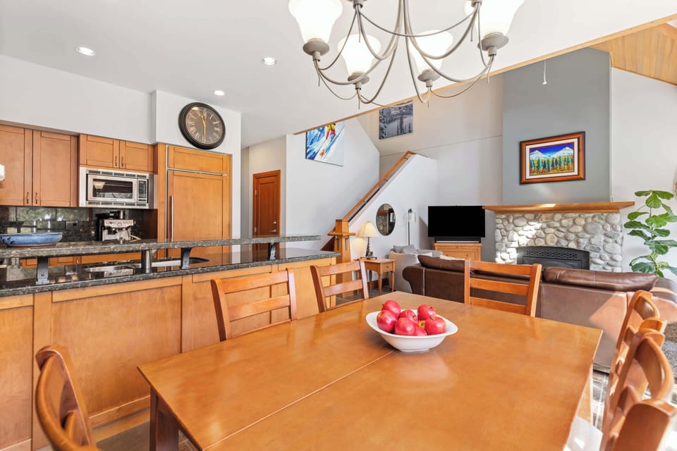 - Dining space with mountain charm and warm lighting  
- Overlooks living room and stone fireplace view  
- Great for family dinners after days on the slopes  
