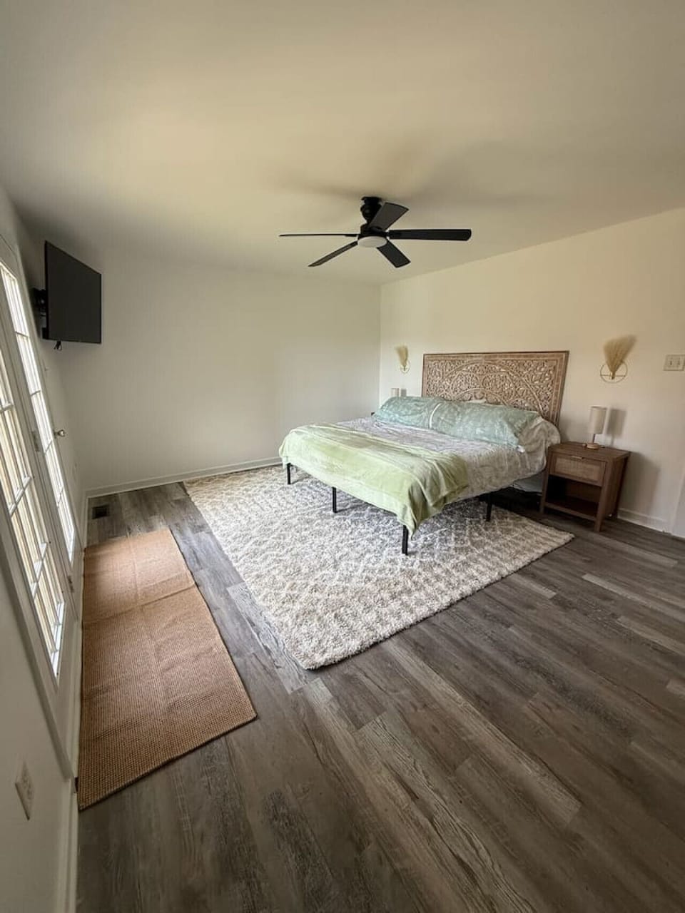 Retreat to luxury in this master suite featuring a king-size bed, Roku flat-screen TV, ceiling fan, and a private ensuite bathroom. Step onto the balcony for breathtaking views.