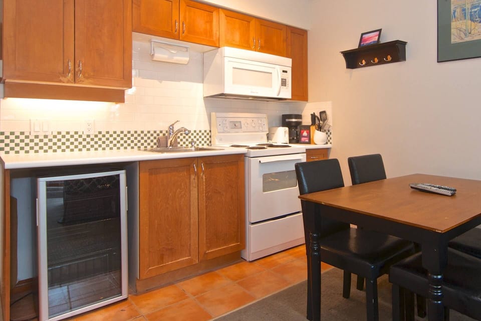 Kitchen with full size stove, microwave and condo size fridge