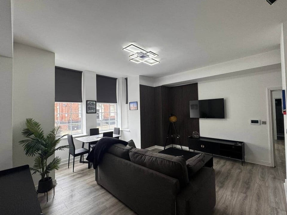 living area with sofa, dining area and smart tv
