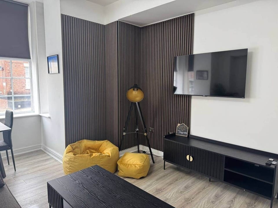 living area with sofa, dining area and smart tv
