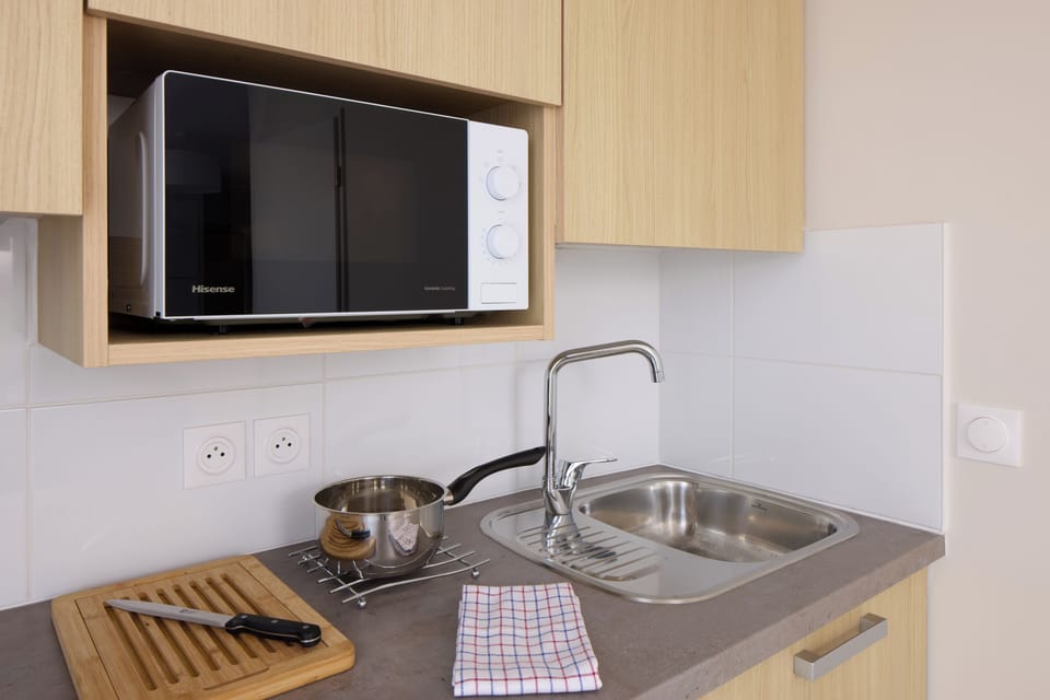 Mini-fridge, microwave, stovetop, cookware/dishes/utensils