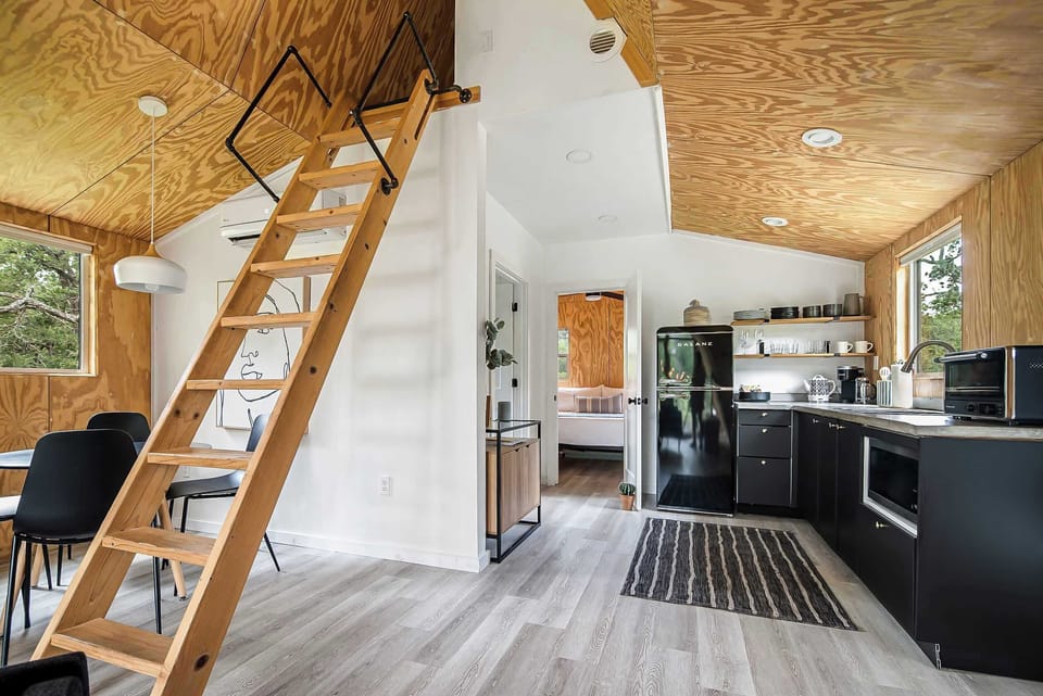 Bright and spacious kitchen with a dining nook and ladder to the loft. 