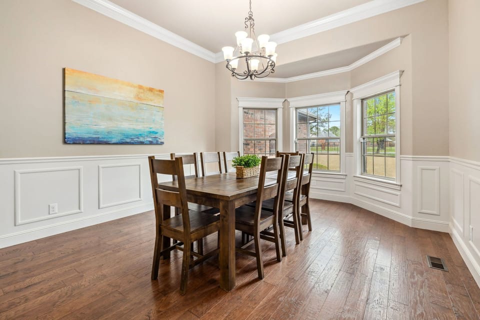 A spacious, long rectangular table that comfortably seats eight, perfect for meals, gatherings, and shared moments.