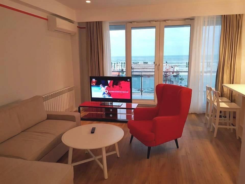 Deluxe Apartment, Balcony, Sea View | Living area | 165-cm LED TV with cable channels