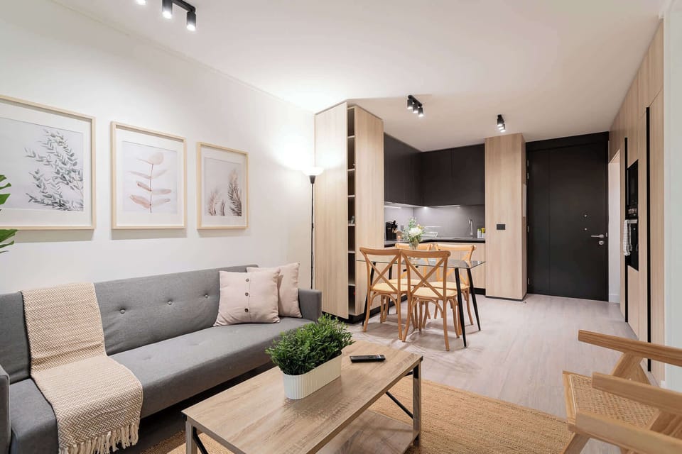 Experience modern comfort in this stylish living space, featuring a cozy dining area and chic decor, perfect for relaxation after a day of adventure.