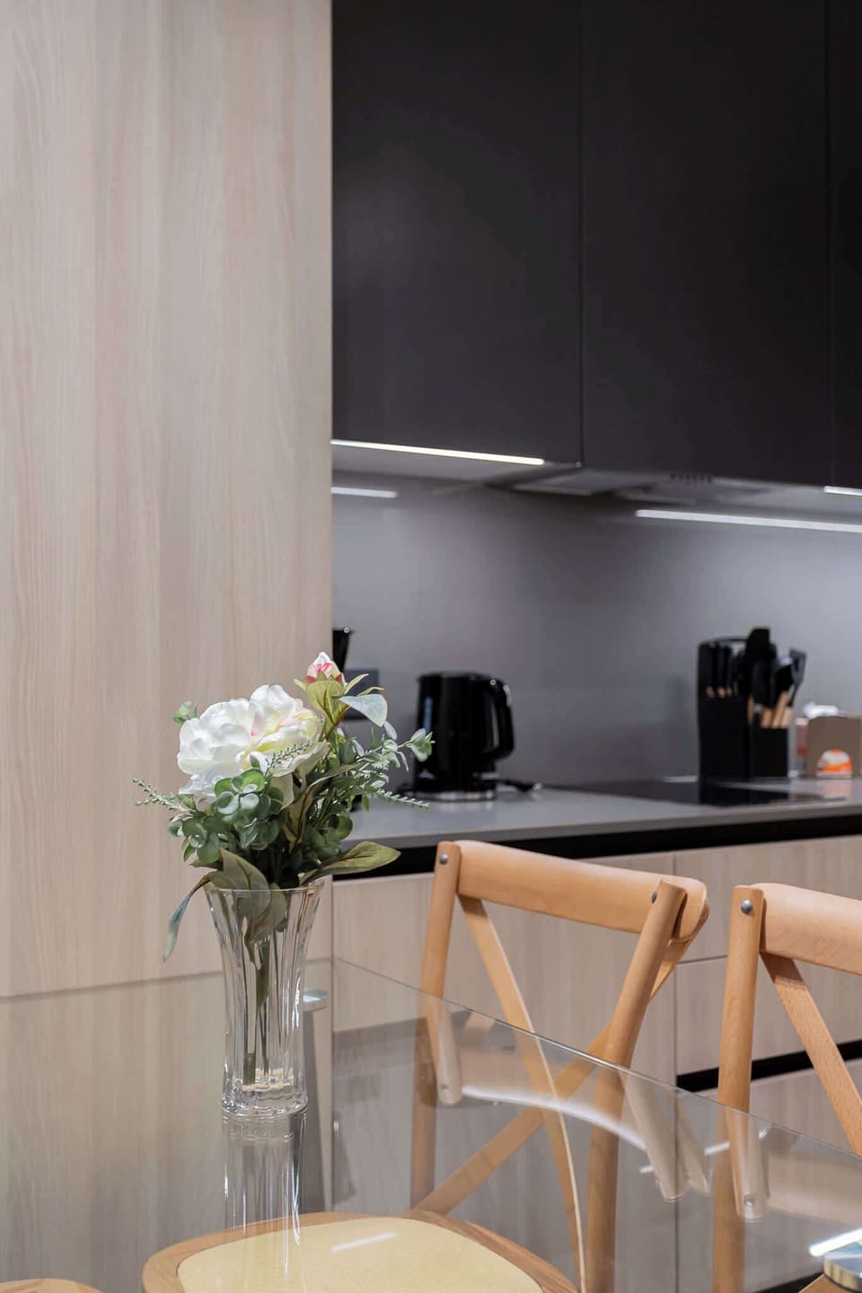 Modern kitchen with sleek cabinetry and a cozy dining area, perfect for family meals and gatherings.