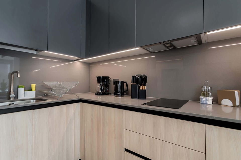 Sleek kitchen with modern appliances and stylish finishes, perfect for culinary enthusiasts.