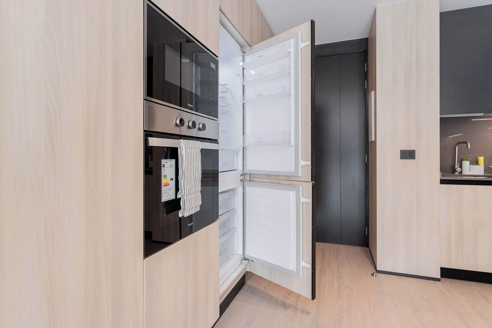 Savor your culinary creations in this sleek, modern kitchen with top-notch appliances and minimalist design.