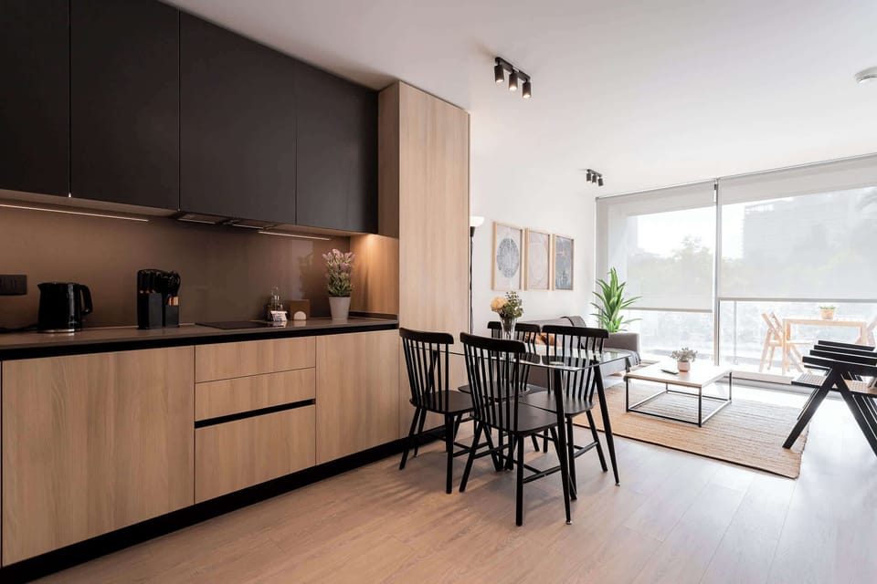 Savor meals in this chic kitchen and dining area, bathed in natural light with modern decor and a cozy vibe.