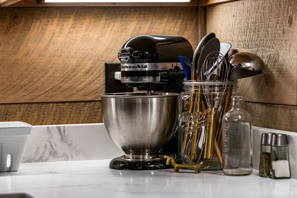 The well-stocked kitchen includes a KitchenAid mixer and high-quality utensils, perfect for cooking or baking during your stay.