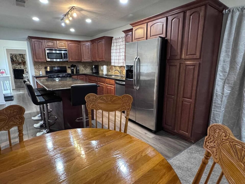 There are two dining areas, 4 comfortable seats at the expansive granite center island, and 4 more at the dining table.