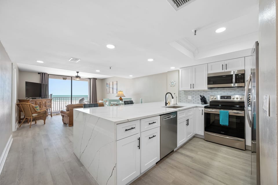 Open-concept kitchen featuring updated appliances and plenty of counter space