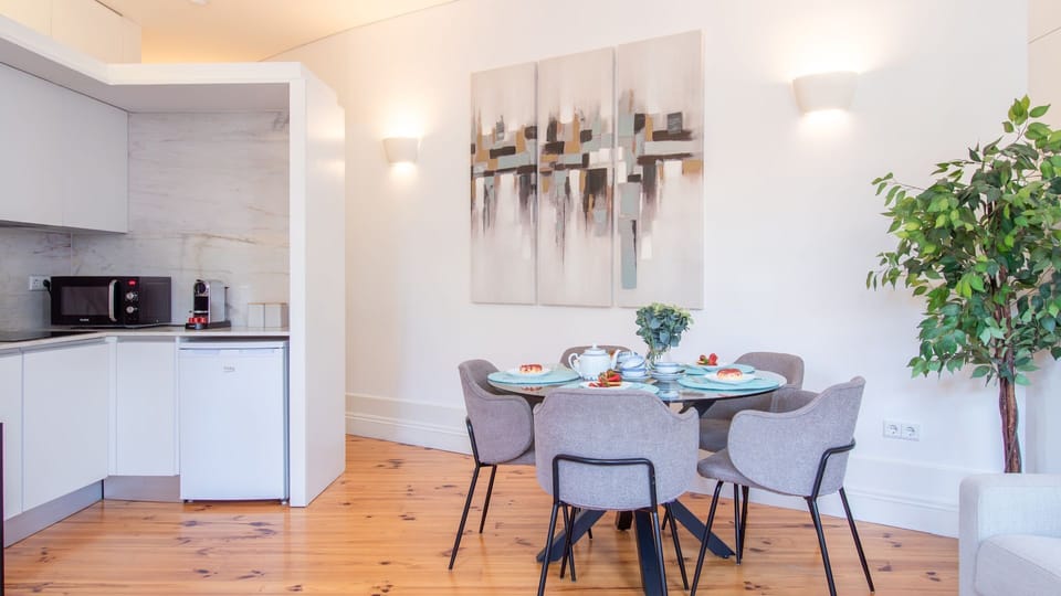 Enjoy the open-plan living where the fully equipped kitchen flows seamlessly into the dining area, creating a perfect space for cooking, eating, and socializing. The contemporary art adds a touch of homey sophistication to your stay.