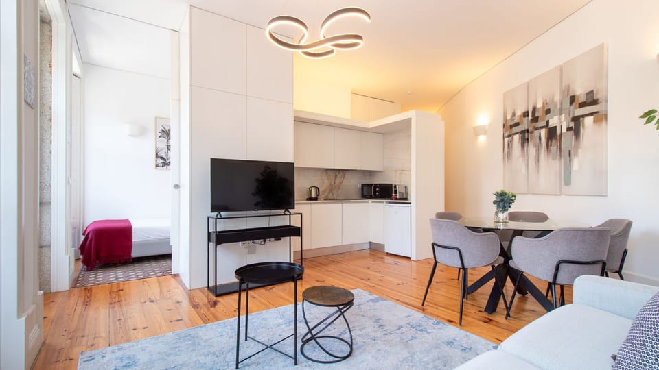 Relax in the inviting living area, perfect for unwinding with a movie, or enjoy a meal at the dining table, all within a beautifully integrated, modern space. #OpenConcept #LivingDining #ModernApartment #CozyNook