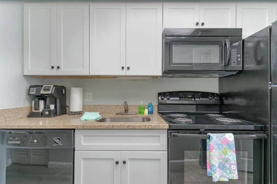 Sleek kitchen area designed for quick cooking & snacks