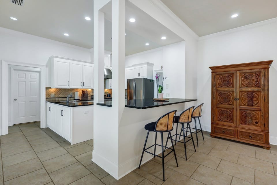 Open kitchen with bar top seating.