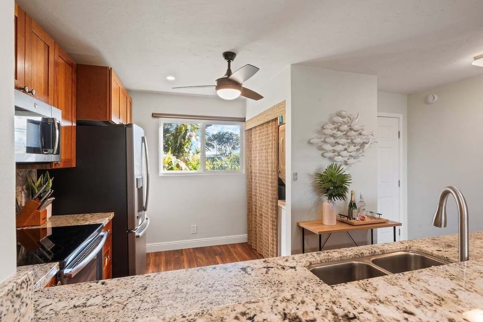 Bright kitchen corner with granite countertops, modern cabinetry, and natural light for a warm, inviting cooking space.
