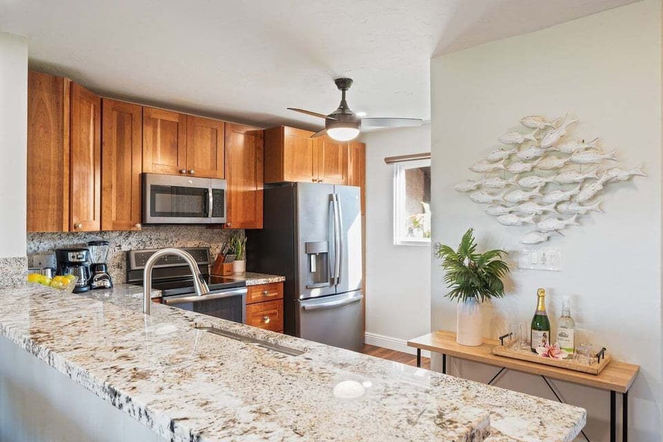 Stylish kitchen featuring modern cabinetry, spacious counters, and natural light for a fresh, functional cooking space.