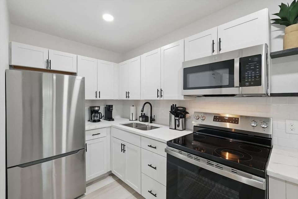 Sleek & Functional Kitchen Setup” Whip up your favorite meals with modern appliances, a full knife set, and ample counter space — all in a clean, stylish design.