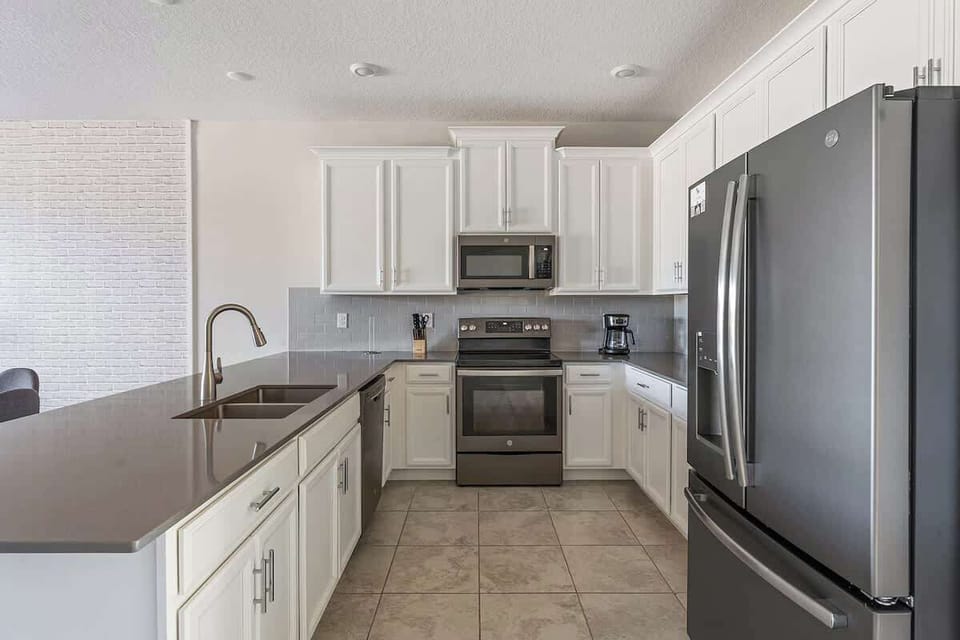A fully equipped kitchen with an open design that connects to the dining and living areas, making it the perfect space for cooking, eating, and spending time with loved ones.