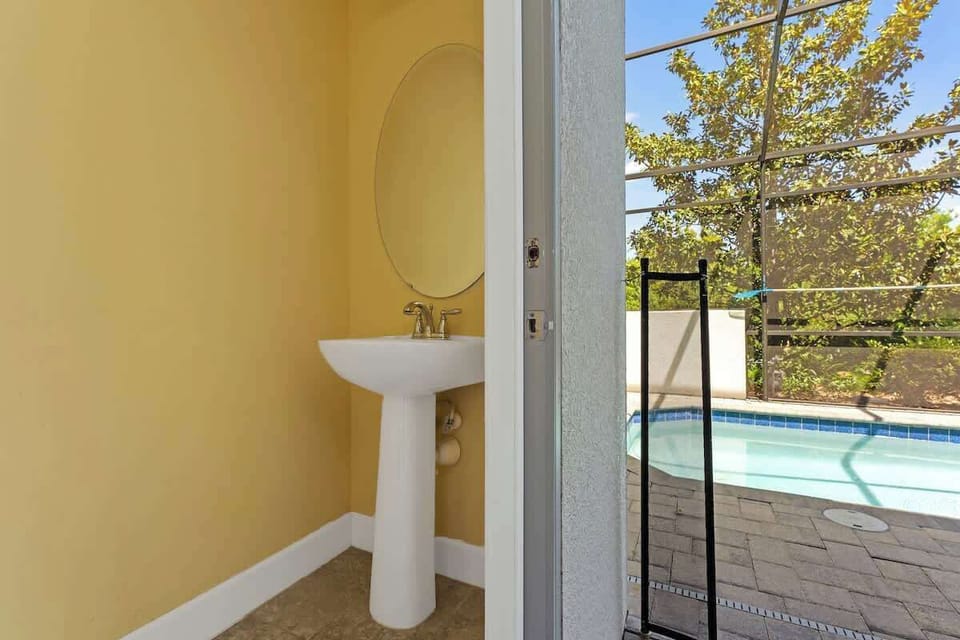 Convenient half bathroom located in the pool area.
