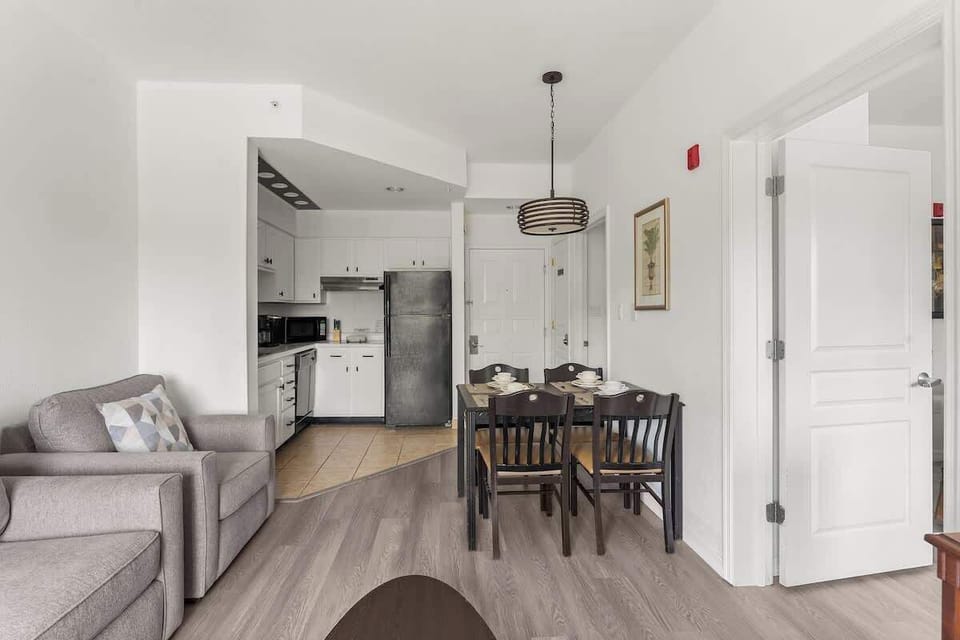 Living room and dining room integrated featuring four seats and a pool view. 