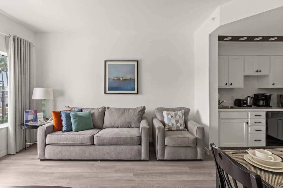 Living room, dining room and kitchen integrated featuring a pool view and a sofa bed. 