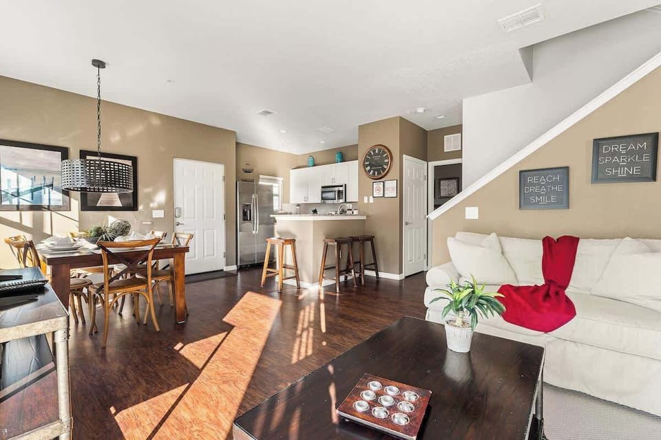 View of the living room facing the back area of the house  and the dining area