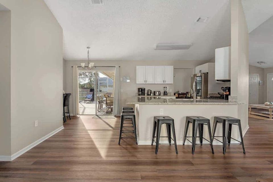 A spacious kitchen with modern appliances, and a beautiful view of the pool.