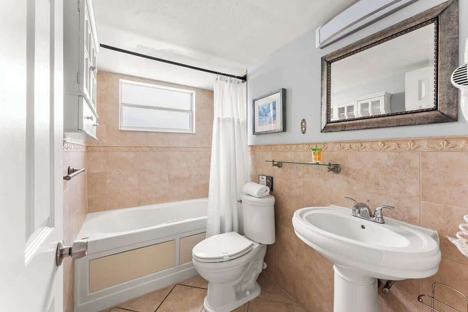 Full bathroom with a bathtub located in the hallway.