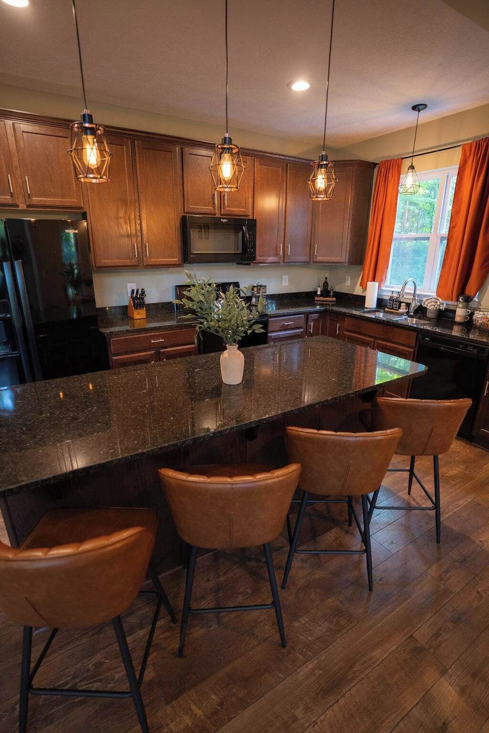 Kitchen: Stylish modern design with sleek granite counters and warm, inviting lighting!
