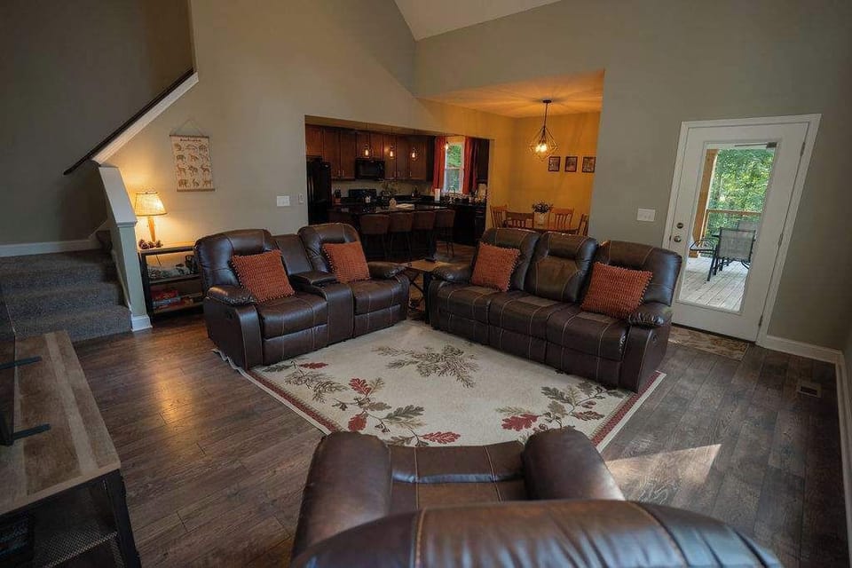 Living Room Retreat: Spacious seating for relaxation with views of nature through bright doors!