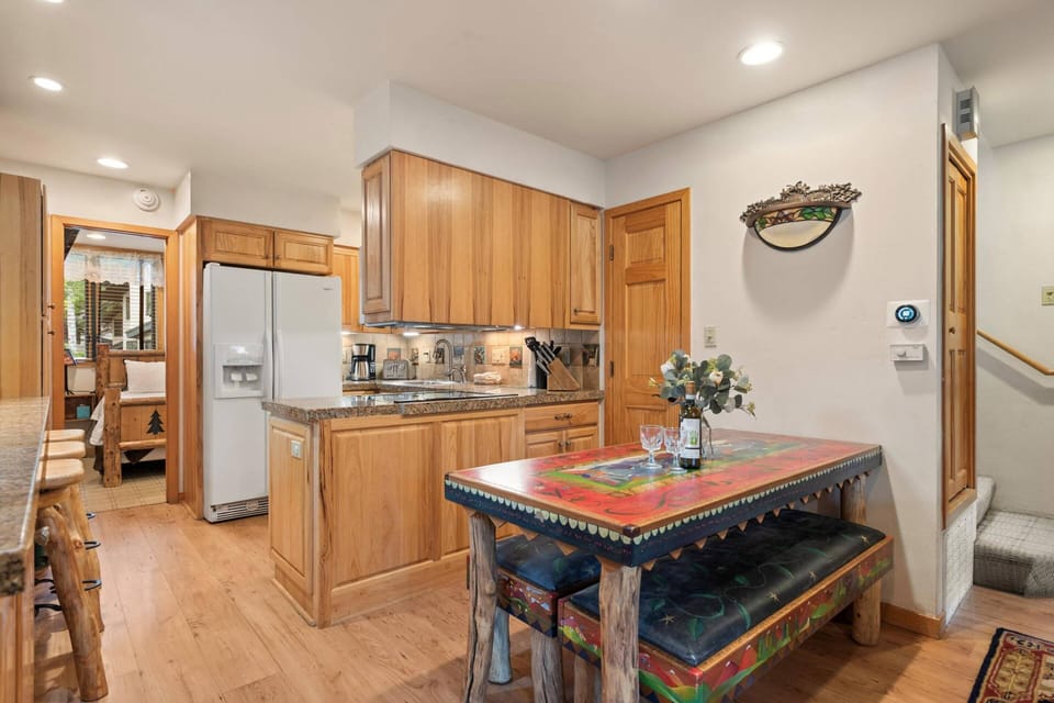 Fully equipped kitchen with granite countertops and handcrafted dining table - everything you need for home-cooked meals and memorable gatherings