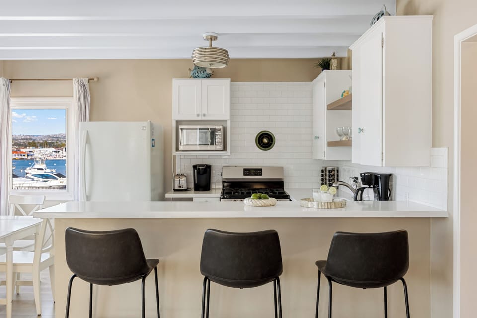 Three bar stools make this kitchen perfect for casual bites or morning coffee.