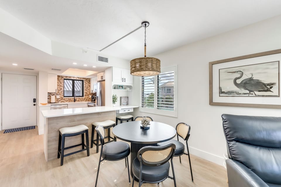 Beautifully designed space includes a breakfast bar with two seats and a desk area for working remotely, along with a table for 4 