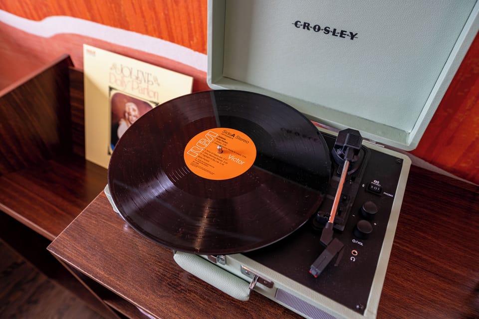 Kick back and enjoy the ultimate music experience with our Crosley record player and a handpicked vinyl collection featuring country legends, rock icons, and hip-hop greats. Whether you’re in the mood for Johnny Cash’s storytelling, Dolly Parton’s charm, the rebellious energy of the Rolling Stones, or Lil Wayne’s smooth beats, we’ve got something for every taste.