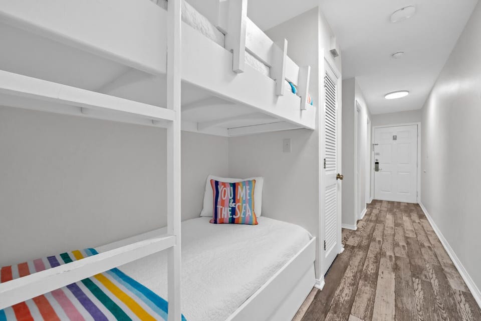 Your kids will love this cheerful bunk bed nook with colorful bedding and built-in storage, perfect for exciting sleepover adventures.