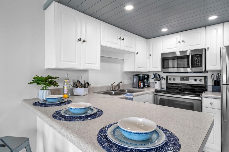 Cook your favorite meals in this bright, fully-equipped kitchen with modern appliances and ample counter space for comfortable meal prep.