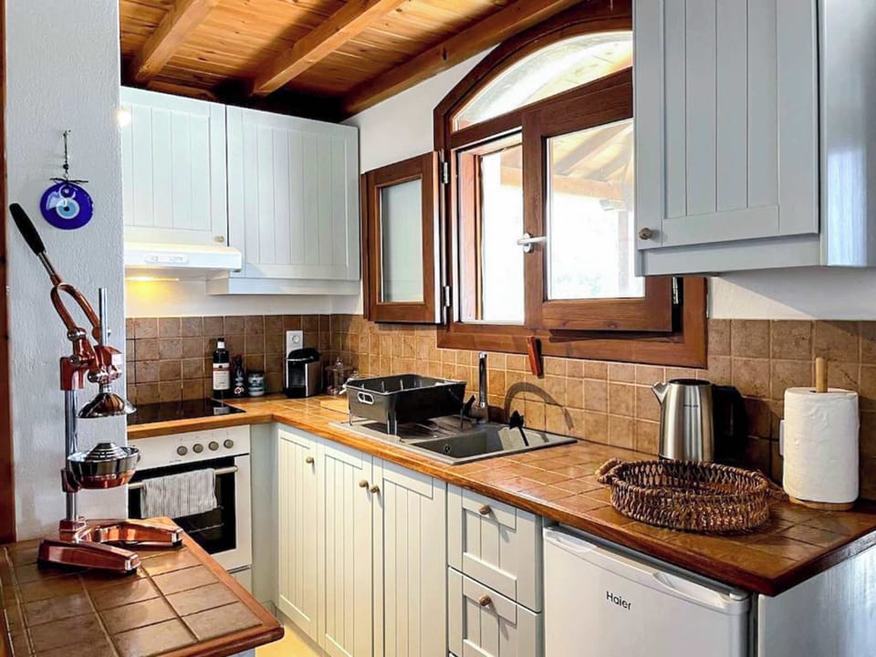 Cook like home with all essentials in a beautiful wooden setting.
