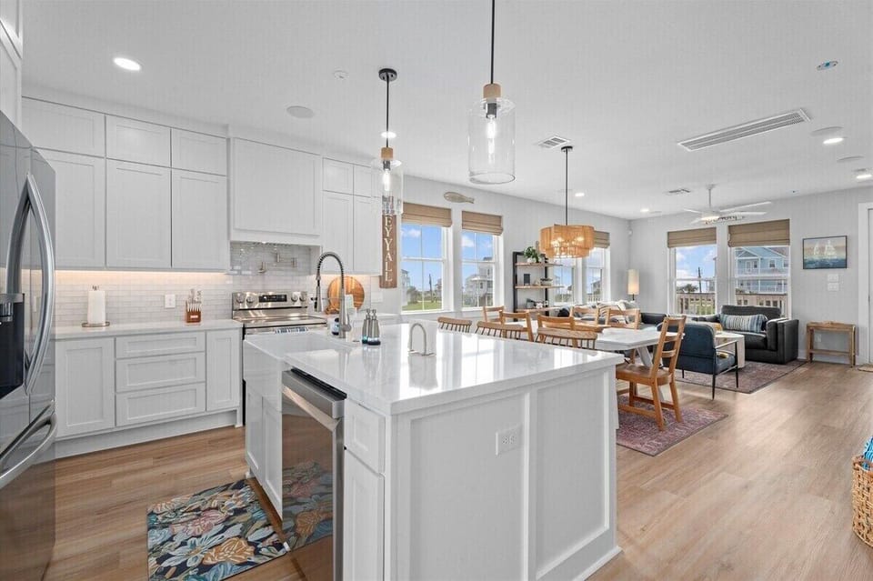 Fully equipped kitchen with large island, stainless steel appliances, and ample counter space for cooking.