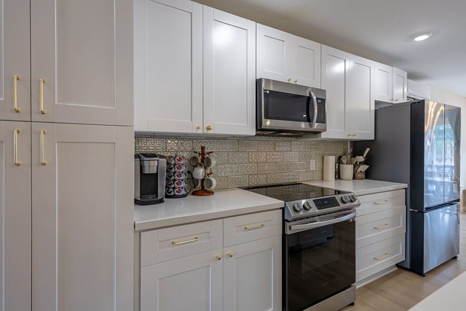 Cook up something delicious in the fully stocked 2nd floor kitchen — sleek appliances and counter space ready whenever inspiration strikes.