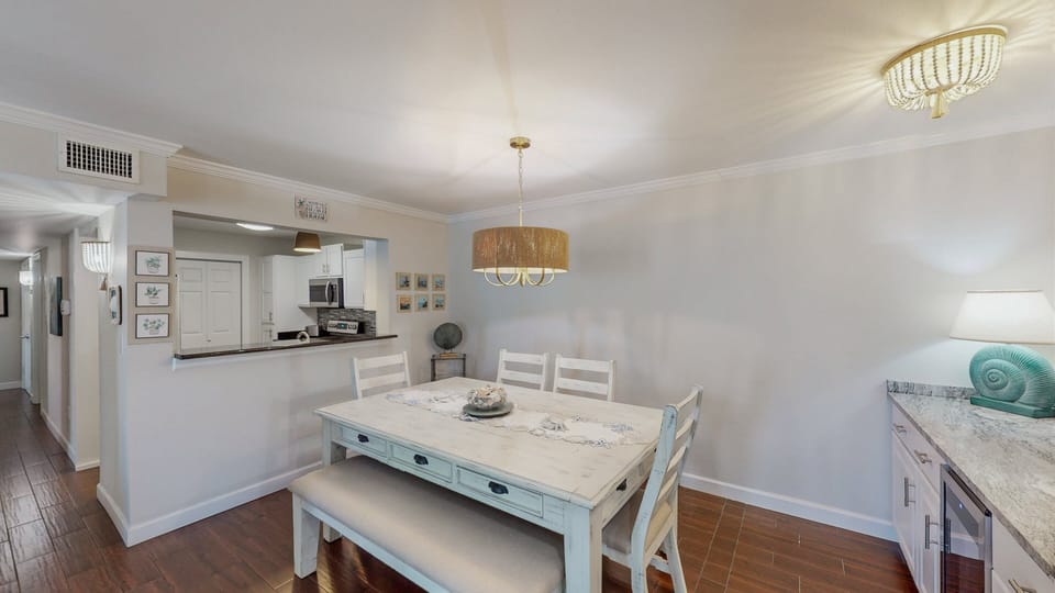 The convenient opening over the bar between the kitchen and dining area combine the space to create the heart of the home.