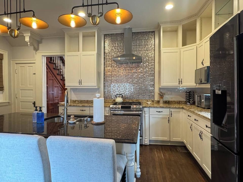 Spacious and stylish kitchen with granite countertops, and large center island