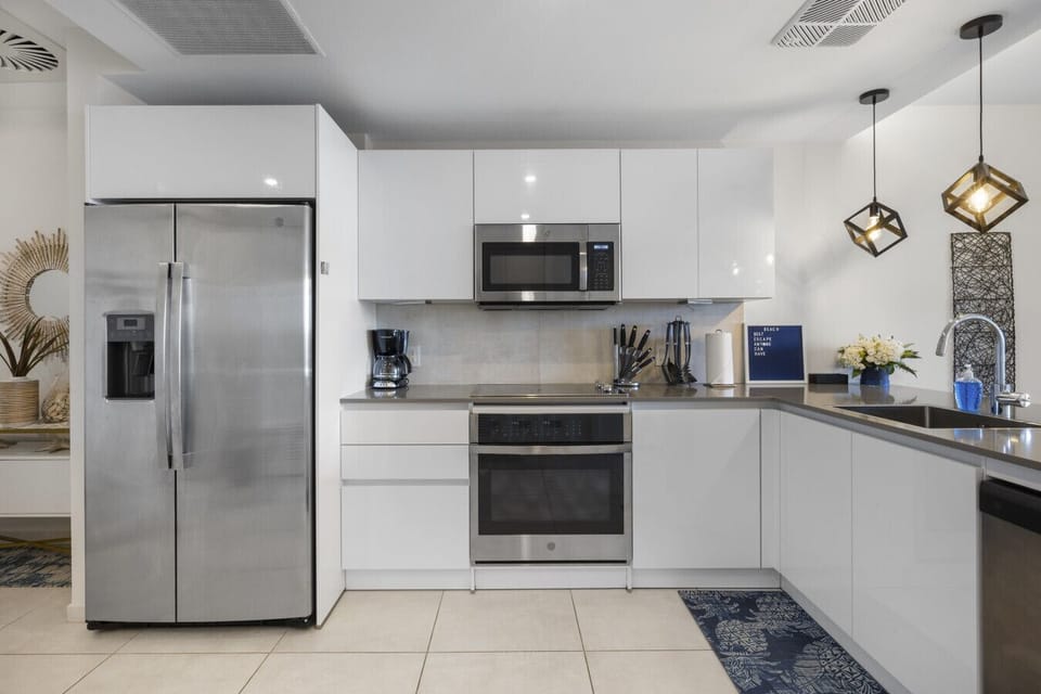 Discover culinary bliss in this contemporary kitchen, featuring stylish finishes and modern appliances. Perfect for creating delicious meals during your stay!