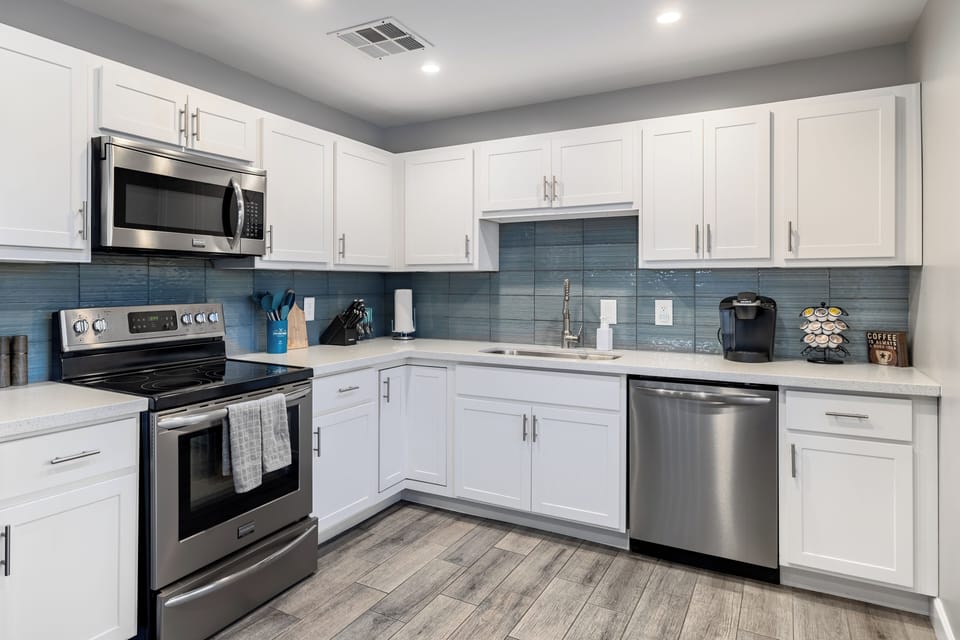 Fully equipped kitchen with stainless steel appliances.