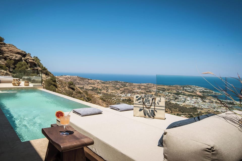 The pool area is equipped with 3 sun beds, two poof loungers, a poolside shower, and one umbrella.