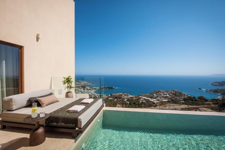 The pool area is equipped with 3 sun beds, two poof loungers, a poolside shower, and one umbrella.