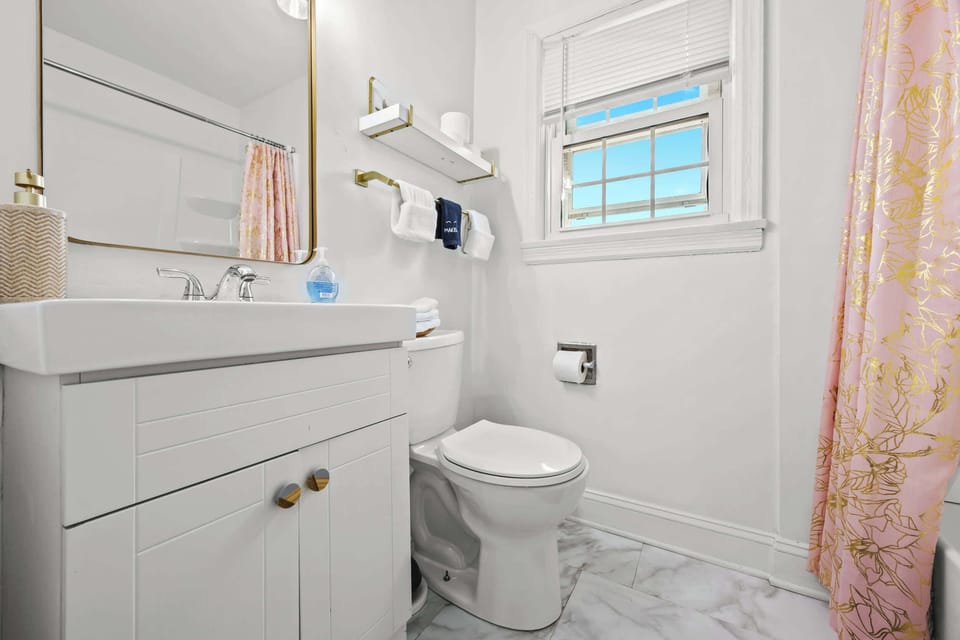 Full Bathroom 1: Unit 1 - Enjoy a spa-like experience in this elegant bathroom with a large vanity and contemporary fixtures.